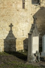 Mazerier village. A weathered tombstone is shown in the daylight. It is near church of St