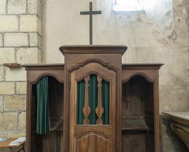 Ancient wooden confessional in a Roman Catholic church. France. Europe