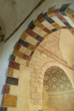 Painted arch in red, yellow and black. St Aignan's Church of Begues. Allier department. Auvergne