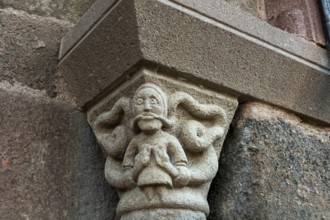 Sculptural details on the porch of the Romanesque church in Azerat village, Haute Loire,