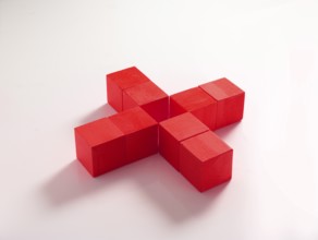 8 red wooden cubes against a white background