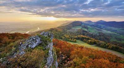 View from the Gisliflue of an autumn-colored forest, behind the Jurassic foothills with water fluh