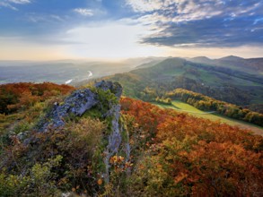 View of an autumnal forest from the Gisliflue, behind the Jura foothills with Wasserfluh and