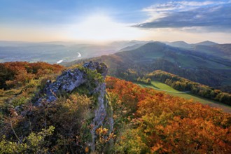 View from the Gisliflue of an autumn-colored forest, behind the Jurassic foothills with water fluh