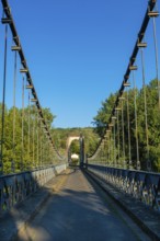 Suspension bridge of Coudes village on river Allier. Puy de Dome. Auvergne Rhone Alpes. France
