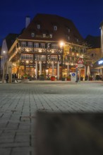 Traditional half-timbered hotel at night with lighting on an urban square, Nagold, Calw district,