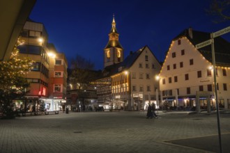 Urban square at night with illuminated half-timbered houses and church tower, Nagold, Calw