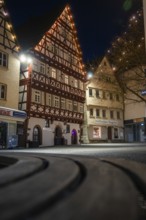 Charming half-timbered houses in an old town, softly lit by fairy lights at night, Nagold, Calw