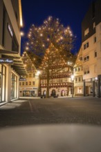 Festively illuminated old town with a large light tree in the evening light, Nagold, Calw district,