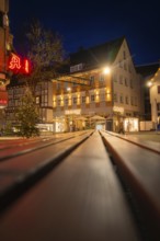 Night scene with illuminated shops and Christmas decorations in a shopping street, Nagold, Calw