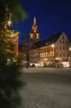 Illuminated house facades in the city center decorated with Christmas lights in the evening,