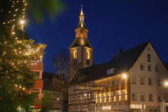 Evening city view with illuminated church and half-timbered house at Christmas time, Nagold, Calw
