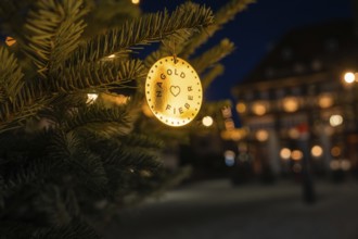 A festively decorated Christmas tree at night with warm lights and blurred background, Nagold, Calw