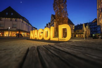 The illuminated Nagold lettering shines at dusk and creates a lively atmosphere in the city center,