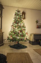 Christmas tree in the living room with lights and red balls, cozy atmosphere, evening mood, Nagold,