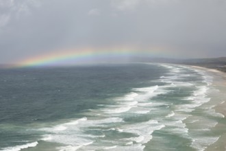 Tallow Beach bay with rainbow, lookout Byron Bay lighthouse, New South Wales, Australia