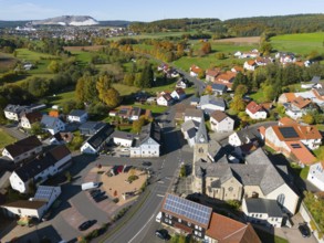 Wide view of a village with church, nestled in an autumn landscape, aerial view, Niederkalbach,