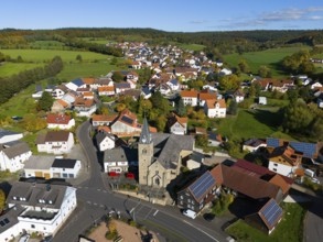 Aerial view of a village with church and many houses in an autumn landscape, Niederkalbach, Kalbach