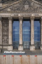 Construction fences and letters with the hashtag We Remember in memory of the victims of fascism