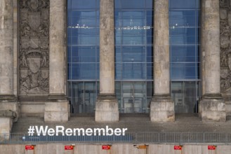 Construction fences and letters with the hashtag We Remember in memory of the victims of fascism