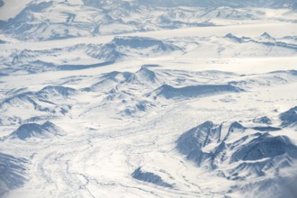 Icy, snowy arctic mountain landscape with glaciers, aerial view, Greenland, Arctic