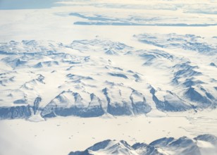 Glacier tongues flow into huge glaciers, snowy arctic mountain landscape, aerial view, Greenland,