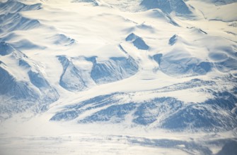 Glacier tongues flow into glaciers, snowy arctic mountain landscape, aerial view, Greenland, Arctic