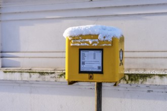 Deutsche Post mailbox covered with snow, Berlin, Germany
