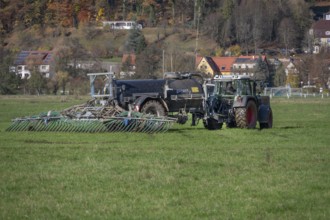 Farmer fertilizing his meadows by tow hose, Eschenbach, Middle Franconia, Bavaria, Germany