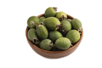 Ripe Feijoa in wooden bowl isolated on white background, side view, close up, minimalism