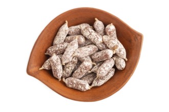 Small smoked Chicken sausages in clay bowl isolated on white background. top view, close up