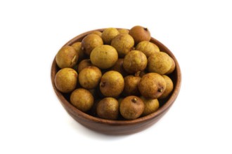Ripe Longan in wooden bowl isolated on white background, side view, close up, minimalism