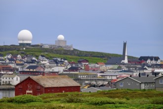 Vardø, Finnmark, Norway, city view with radar towers and a red warehouse in the foreground, under a