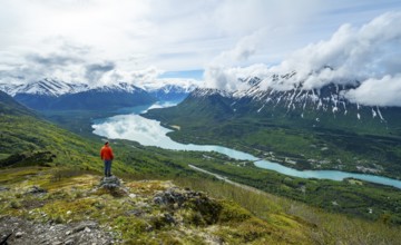 Climber enjoying the view, Slaughter Ridge Trail, view of snowy mountains and turquoise blue Kenai