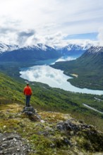 Climber enjoying the view, Slaughter Ridge Trail, view of snowy mountains and turquoise blue Kenai