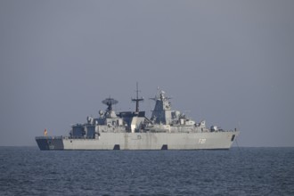 A gray naval vessel from the submarine defense the frigate Bayern F217 on calm seas at roadside off