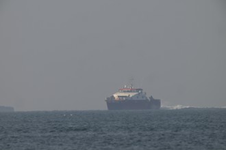 Large ship Catamaran feeder ship for offshore workers at wind farms near Heligoland sails on open
