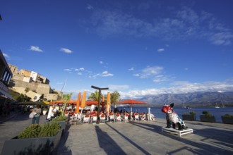 Restaurant at the marina in Calvi, with the mountains of the Balagne region in the Haute-Corse