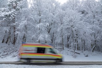 Ambulance driving through snowy landscape, trees, winter, snow, Sieversen, Samtgemeinde