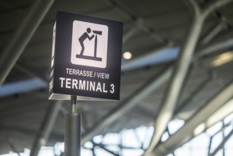 Terminal 3 at Stuttgart Airport. Pictogram viewing terrace. Visitors and aircraft spotters have a