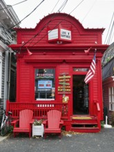 Bright red facade, fast food shop, candy, coffee, inscription love and happiness, American flag,