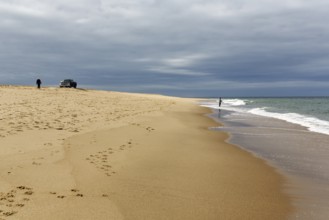 Ocean walkers, fall cloud cover, SUV on horizon, offroad, Provincetown, Race Point Beach, Cape Cod