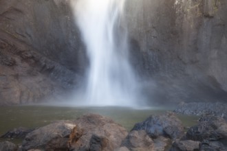 Daytime view from below of Wallaman Falls cascading into a rainforest gorge, Queensland, Australia