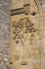 Detail of a historic building with a sandstone tree relief decorated with leaves, Ananuri Castle,