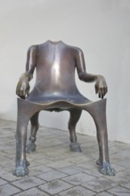 Sculpture The Bub by Lun Tuchnowski, modern art, bronze sculpture, empty chair as an animal figure