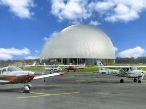 View of flight apron of Essen Mülheim airport with small aircraft parked at the front in the middle