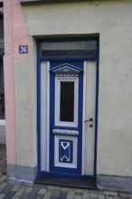 Historically decorated blue door as entrance to a building, a decorative blue wooden door with