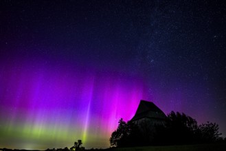 Colourful polar lights over the EXPO observatory in front of a starry night, EXPO Observatory,
