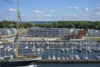 Harbour view with the legendary four-masted PASSAT barque and many boats in front of modern