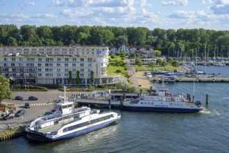 Ferries across the river Trave to Priwall in a busy small port in the town of Travemünde with